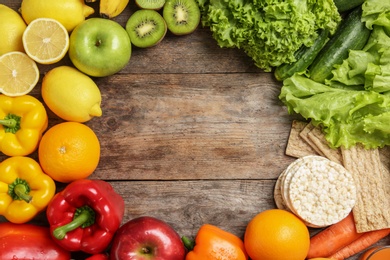 Photo of Flat lay composition with healthy food and space for text on wooden background. Concept of weight loss