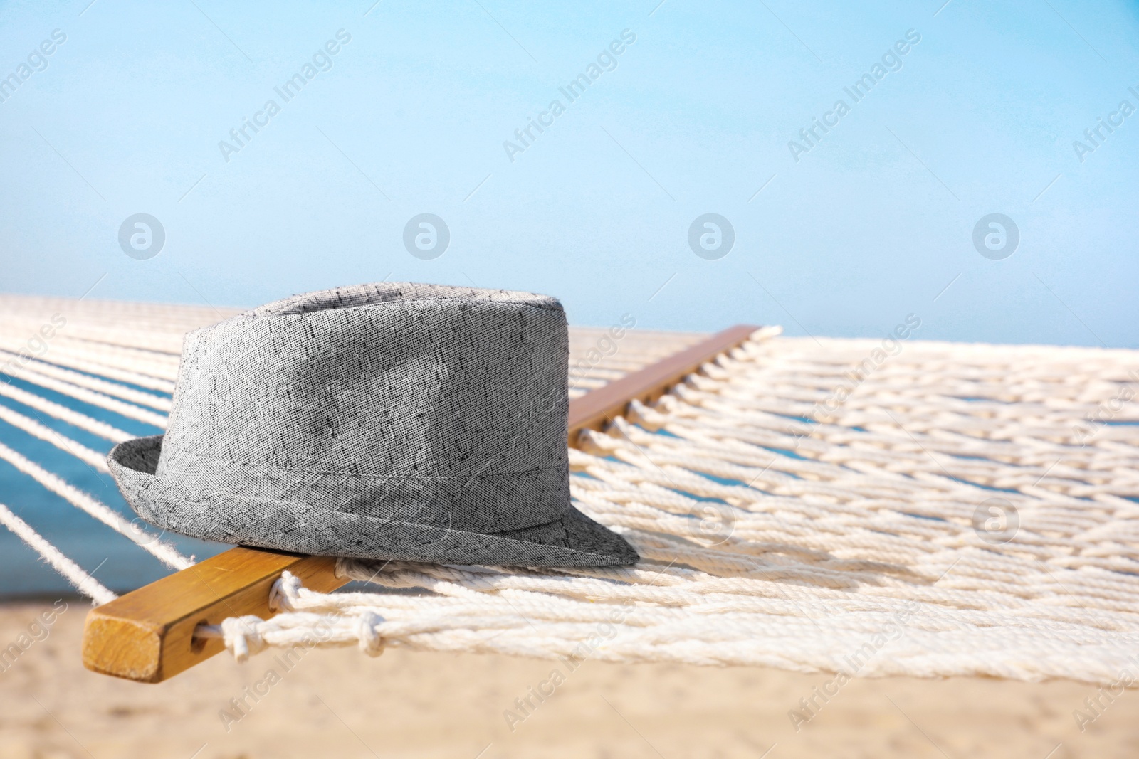 Photo of Hammock and hat at seaside. Time to relax