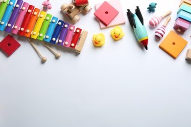 Photo of Flat lay composition with different toys on white background. Space for text