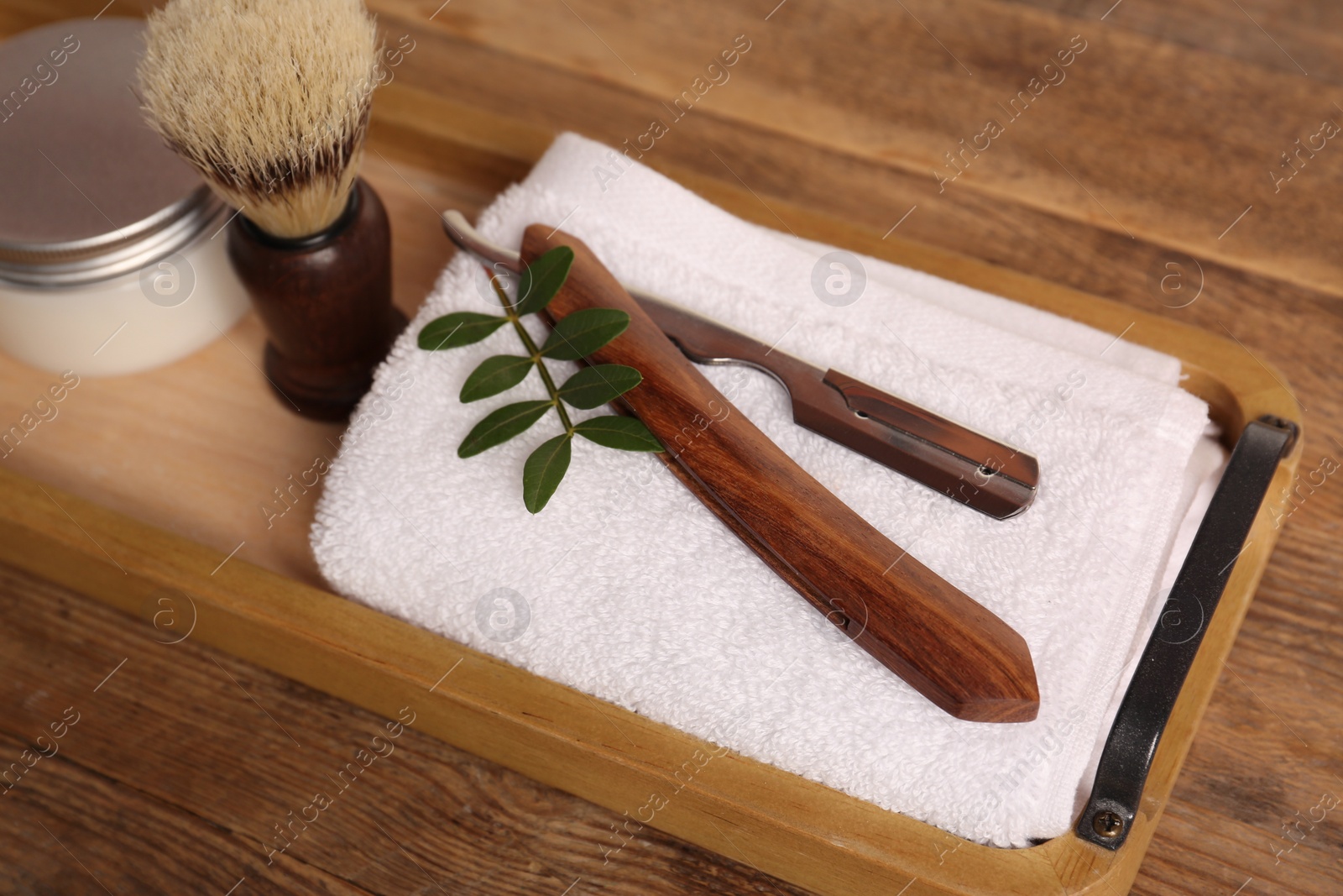 Photo of Set of men's shaving tools on wooden tray