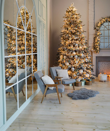 Photo of Festive room interior with stylish furniture and beautiful Christmas tree