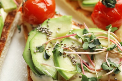 Tasty toast with avocado, sprouts and chia seeds, closeup