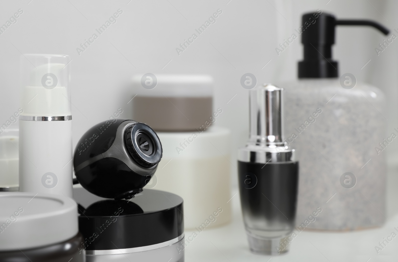 Photo of Camera hidden among different toiletries on table in bathroom