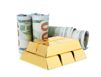 Shiny gold bars and dollar bills on white background