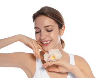 Portrait of young woman with perfect smooth skin and flower on white background. Beauty and body care