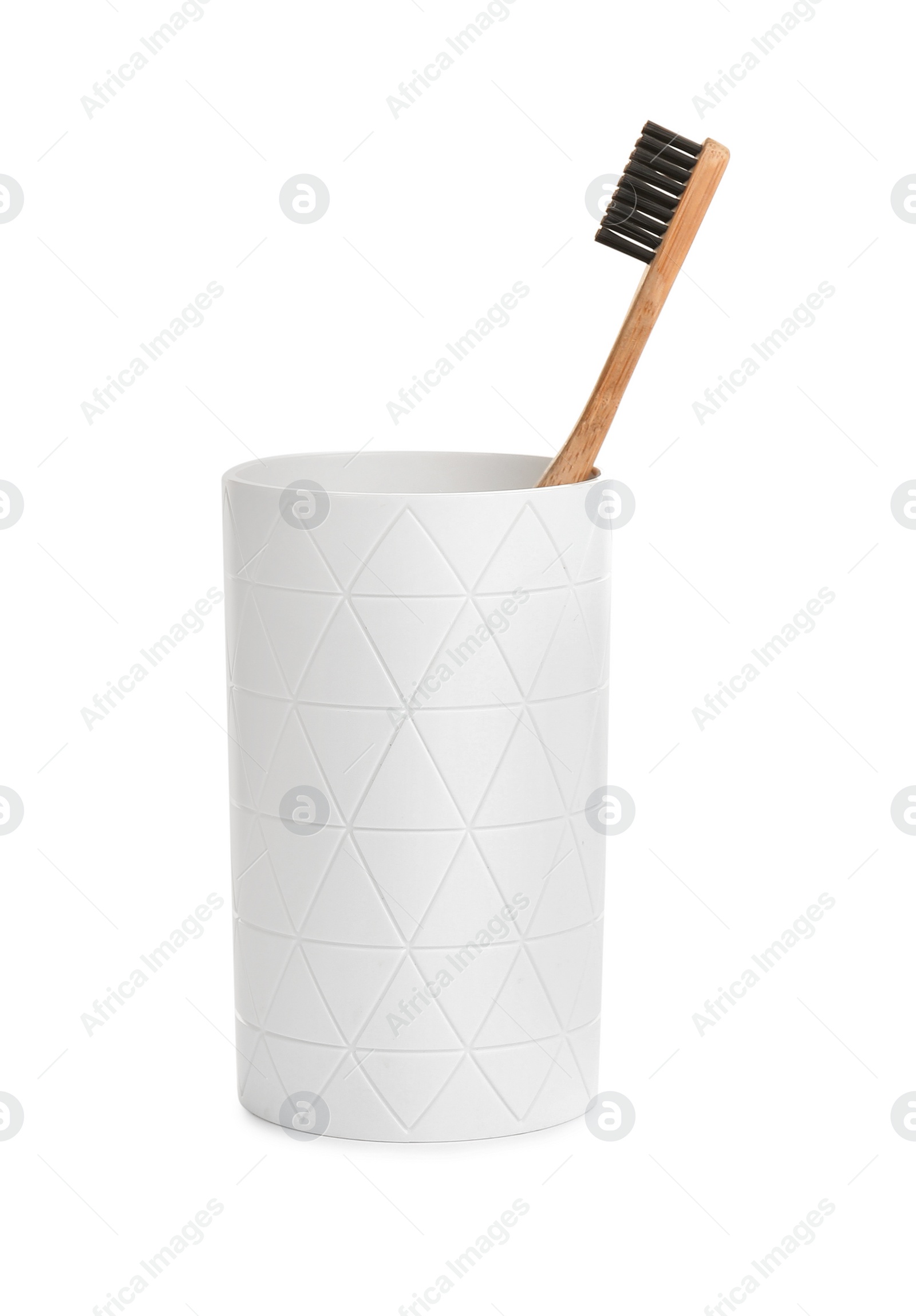 Photo of Bamboo toothbrush in holder isolated on white