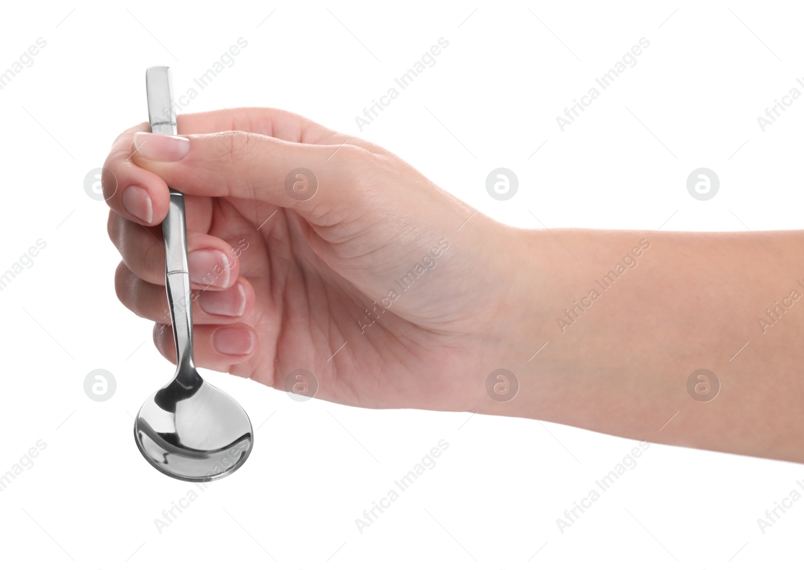 Photo of Woman holding new shiny spoon on white background, closeup