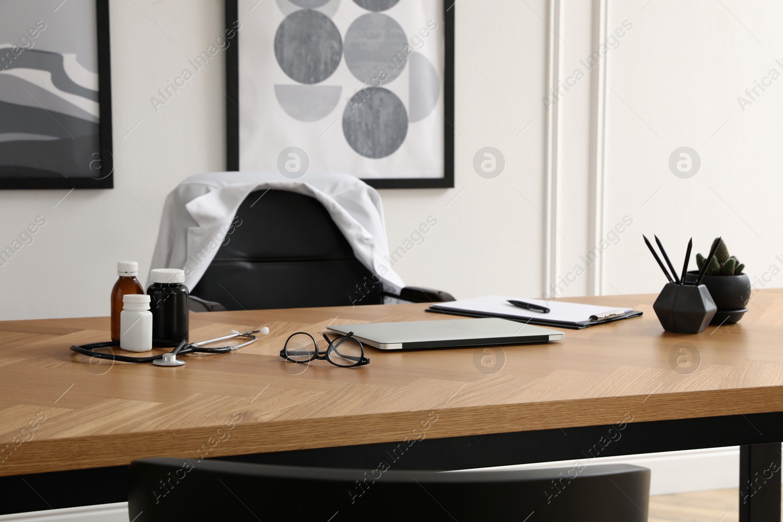 Photo of Modern doctor's workplace in stylish office. Interior design