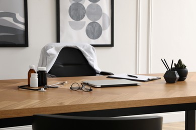 Photo of Modern doctor's workplace in stylish office. Interior design