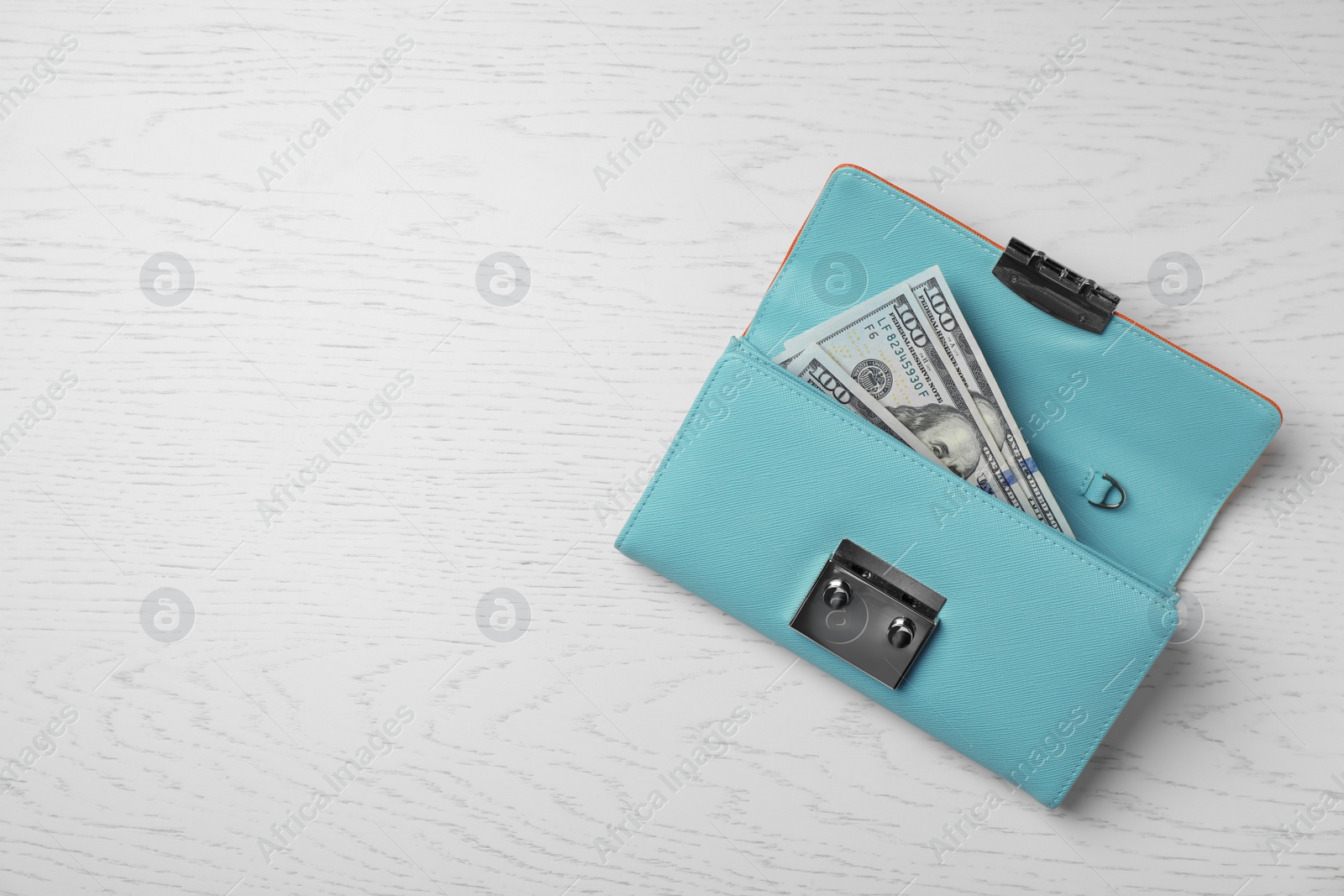 Photo of Stylish wallet with cash on light background, top view