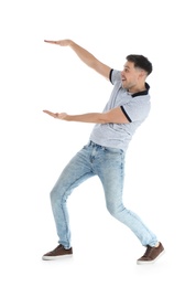 Photo of Emotional man in casual clothes holding something on white background