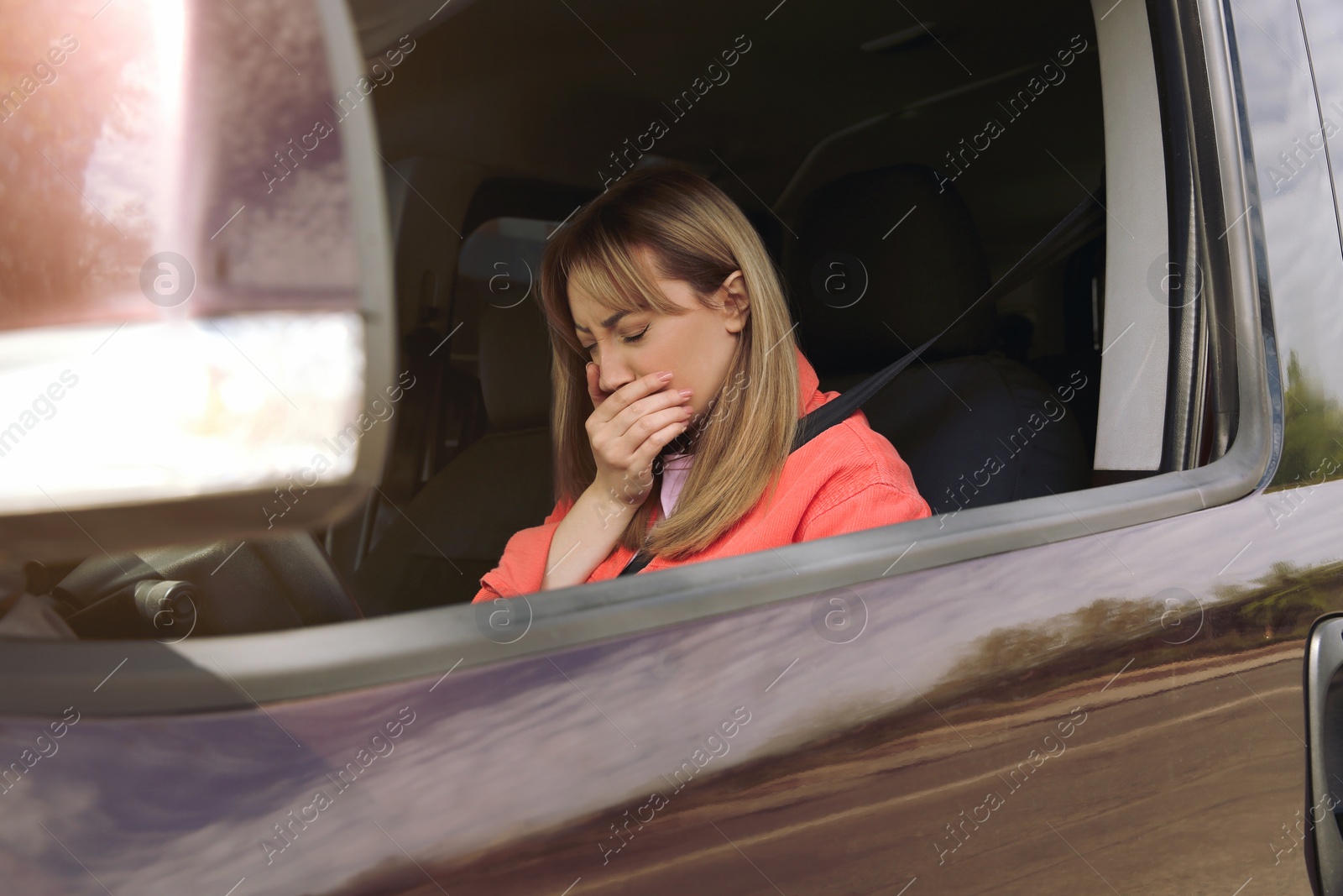 Photo of Young woman suffering from nausea in car