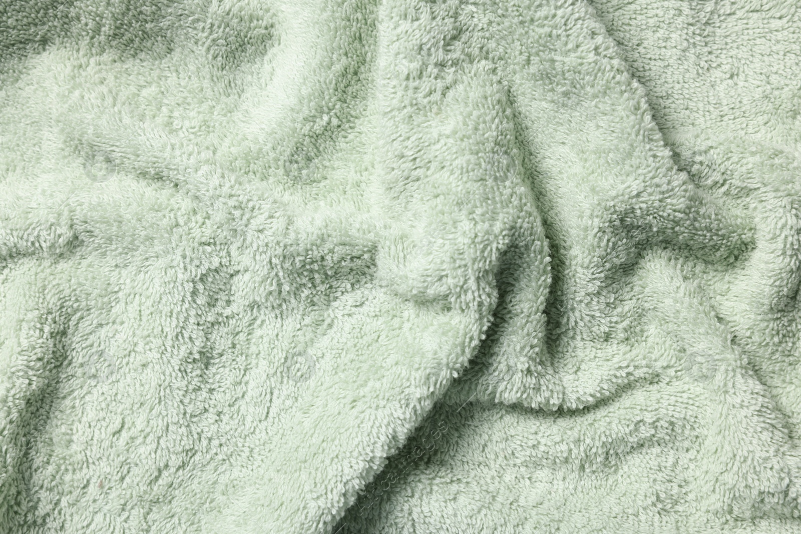 Photo of Texture of soft light green fabric as background, top view