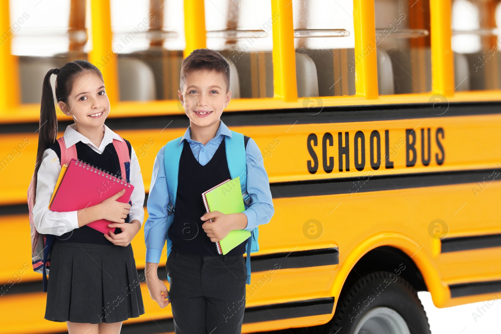 Image of Children with backpacks near yellow school bus. Transport for students