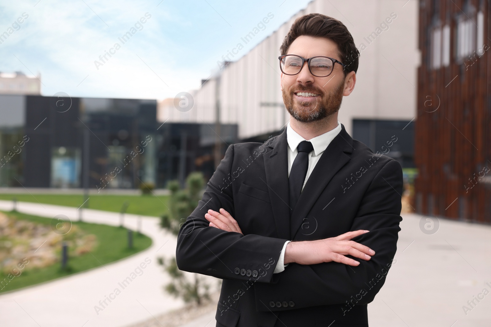 Photo of Handsome real estate agent outdoors. Space for text