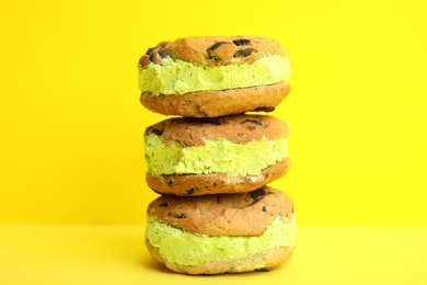 Photo of Sweet delicious ice cream cookie sandwiches on color background