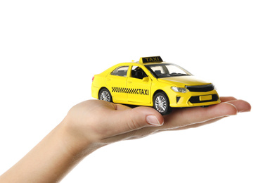 Woman with taxi car model on white background, closeup
