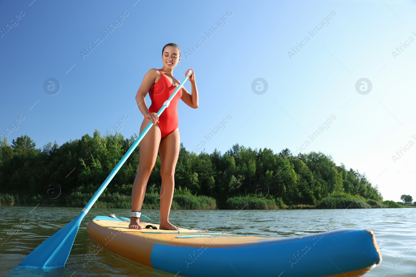 Photo of Woman paddle boarding on SUP board in river