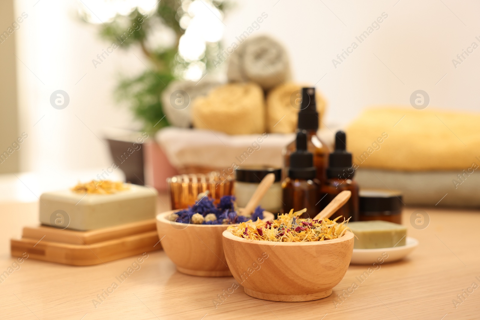 Photo of Dry flowers on wooden table indoors, space for text. Spa time