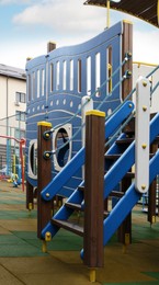 Photo of Outdoor playground for children with blue jungle gym
