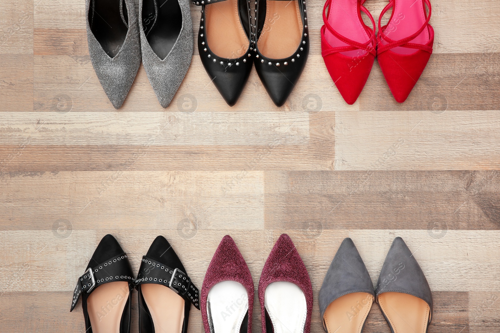 Photo of Different female shoes on floor, top view