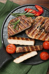 Photo of Grilled pork steaks with rosemary, spices and vegetables on table, top view