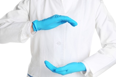 Photo of Doctor in medical gloves showing gesture on white background