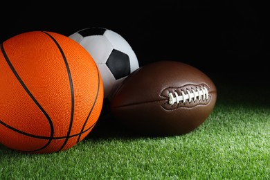 Photo of Set of different sport balls on green grass