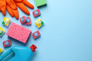 Photo of Flat lay composition with dishwasher detergent pods and tablets on light blue background, space for text