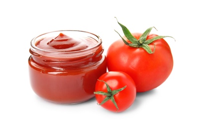 Tasty homemade tomato sauce in glass jar and fresh vegetables on white background