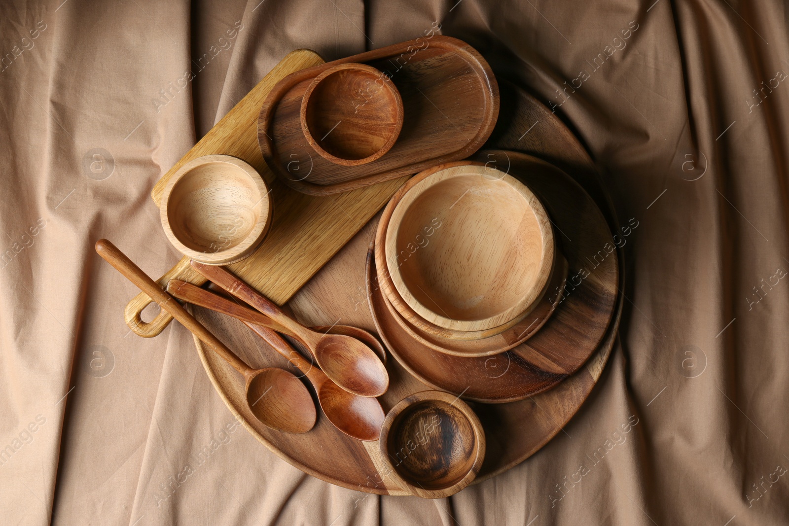 Photo of Set of wooden dishware and utensils on table, flat lay