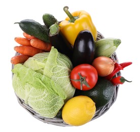 Photo of Wicker basket with fresh ripe vegetables and fruit on white background, top view