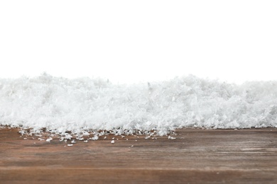 Photo of Heap of snow on wooden surface against white background. Christmas season