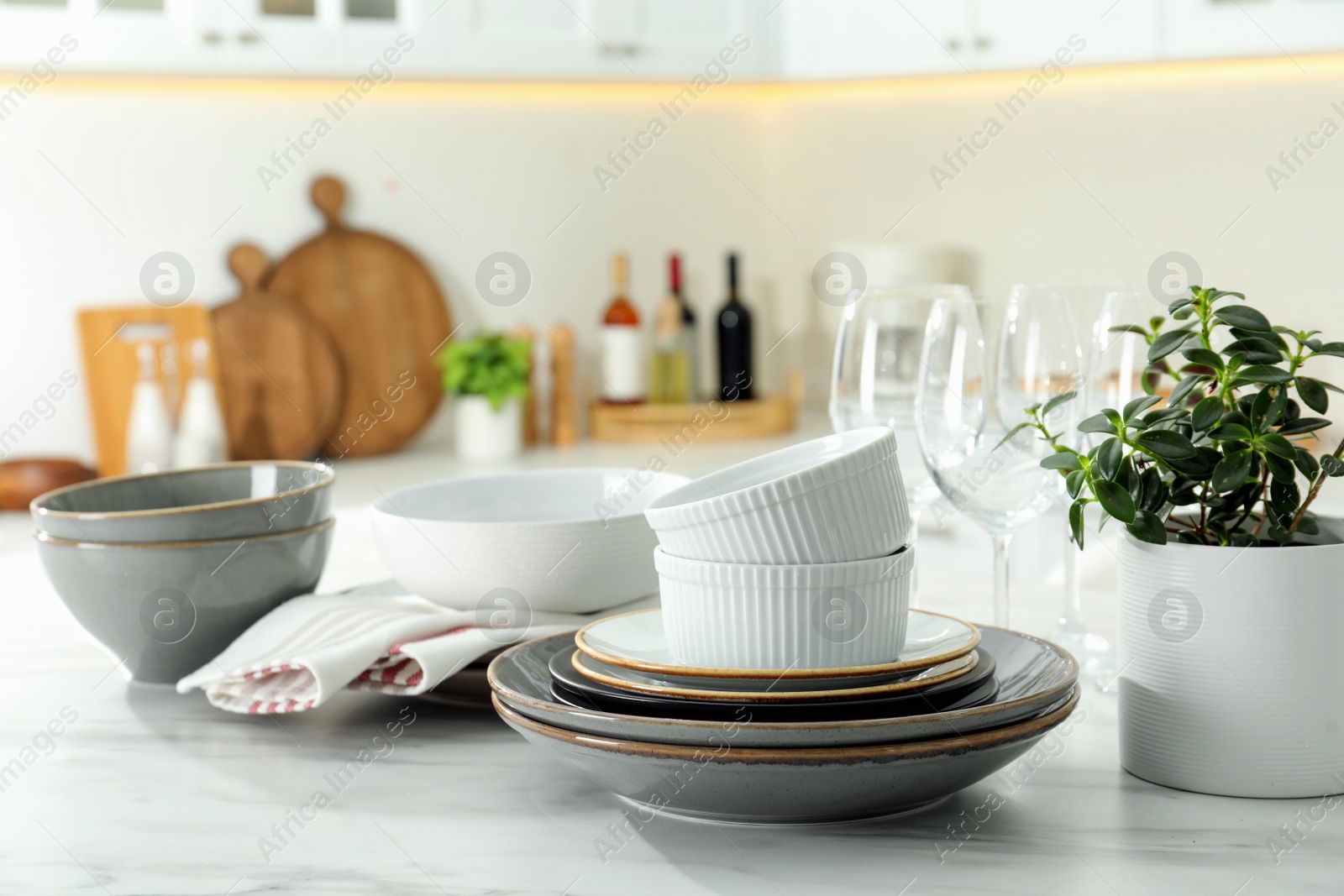 Photo of Set of beautiful tableware on white table in kitchen
