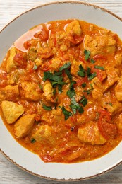 Delicious chicken curry on table, top view