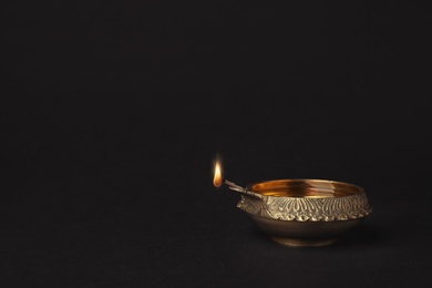 Photo of Diwali diya or clay lamp on dark background