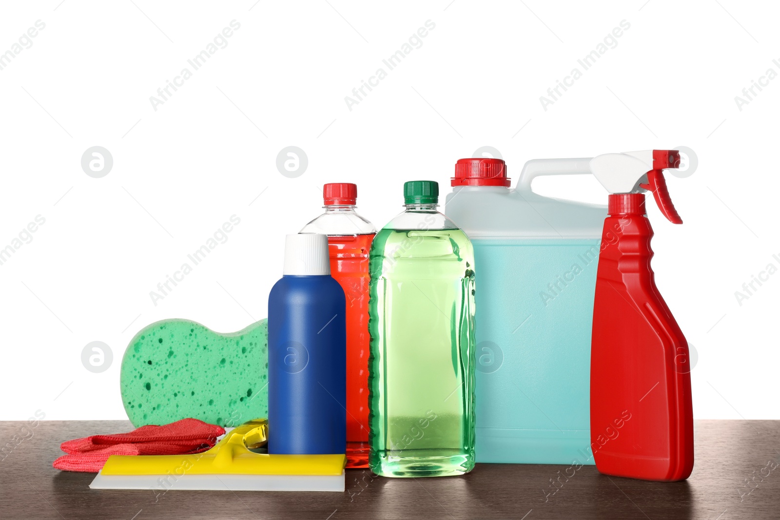 Photo of Many different car wash products on wooden table against white background