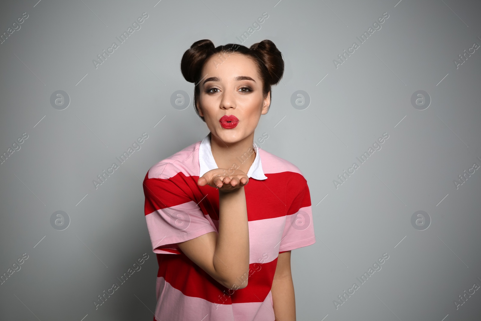 Photo of Portrait of beautiful young woman on grey background