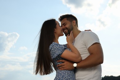 Photo of Romantic date. Beautiful couple spending time together against blue sky