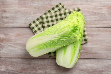 Fresh ripe Chinese cabbages on wooden table, top view