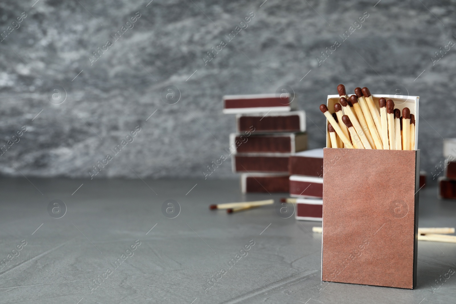 Photo of Composition with matches on table against grey background. Space for text