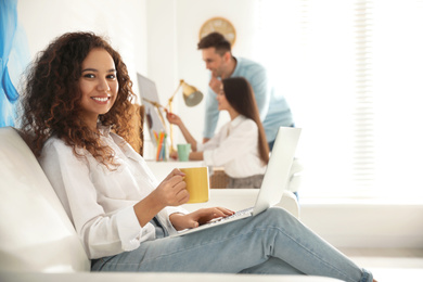 Photo of Professional designer working with laptop in modern office