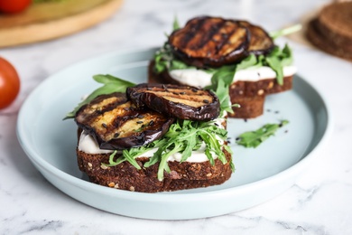 Photo of Delicious eggplant sandwiches served on white marble table