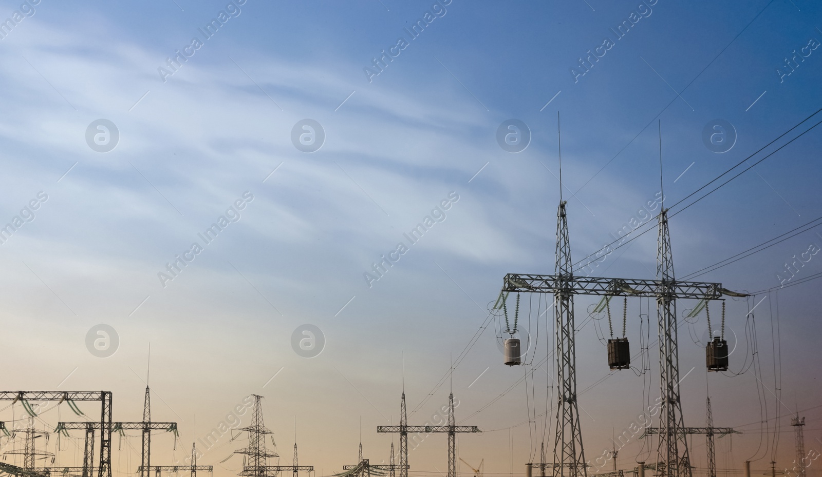 Photo of Modern electrical substation at sunset, low angle view