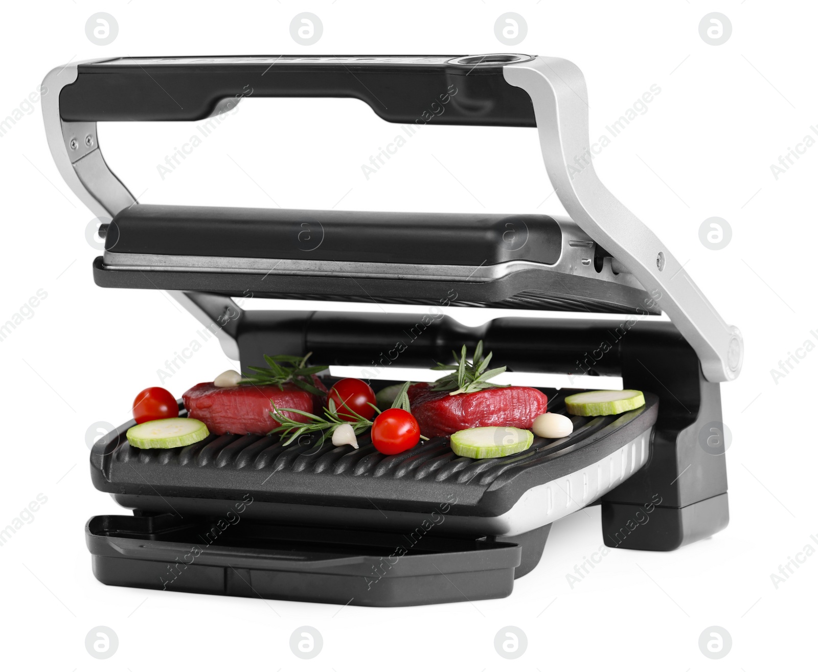 Photo of Electric grill with raw meat, rosemary and vegetables isolated on white