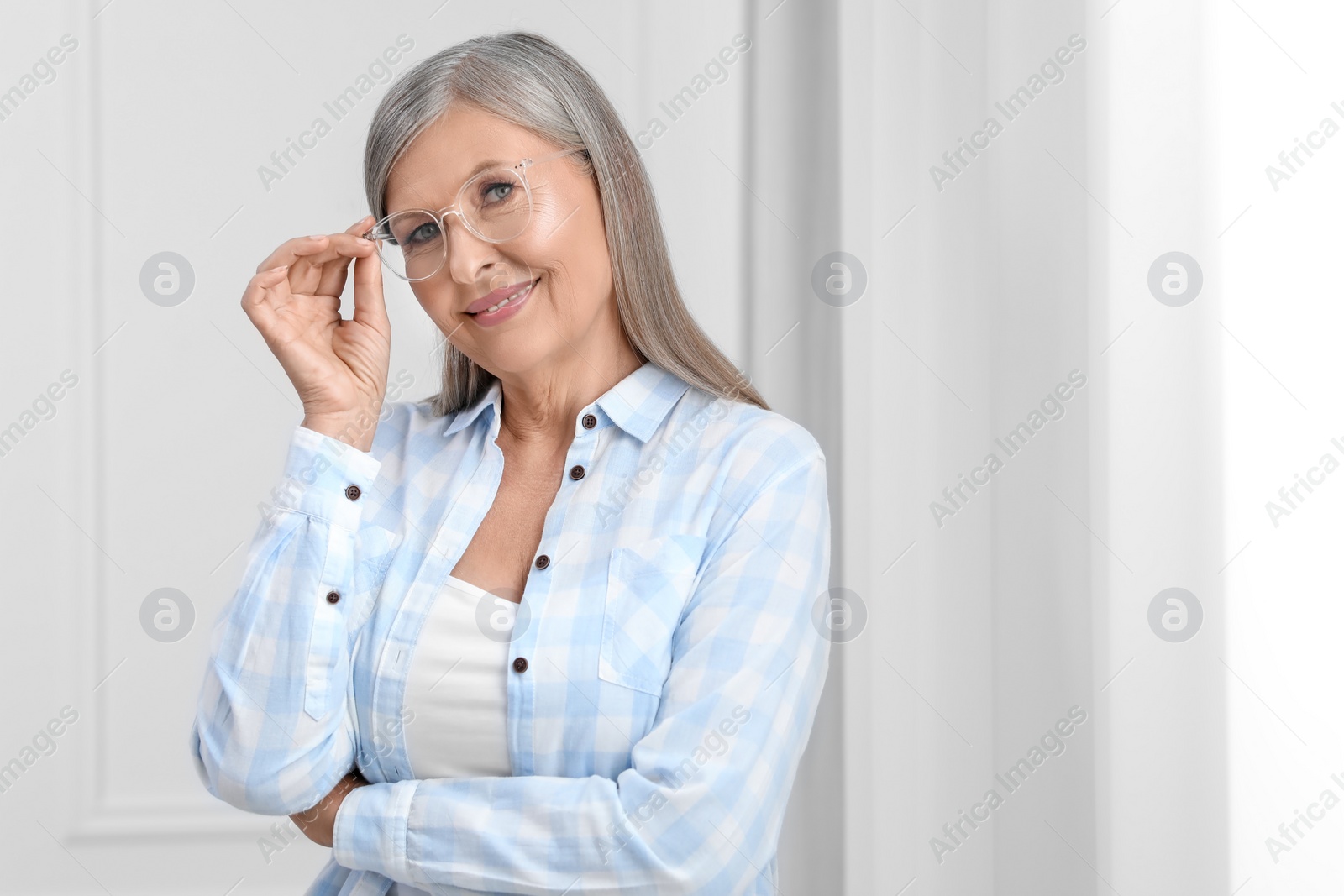 Photo of Portrait of beautiful senior woman in glasses indoors. Space for text