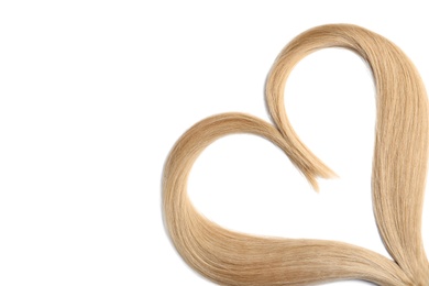 Heart made of blond hair locks on white background