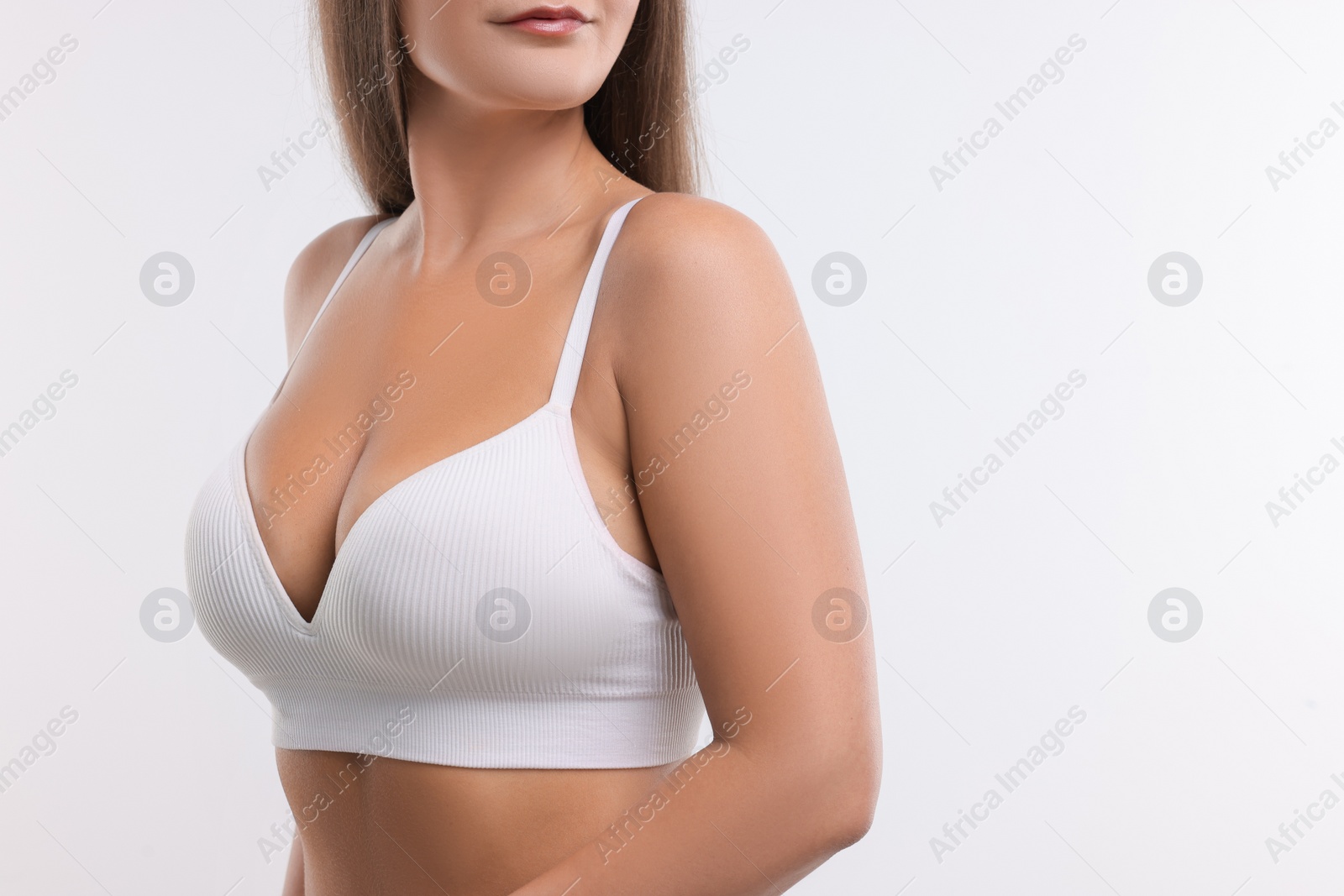 Photo of Woman with beautiful breast on white background, closeup. Space for text