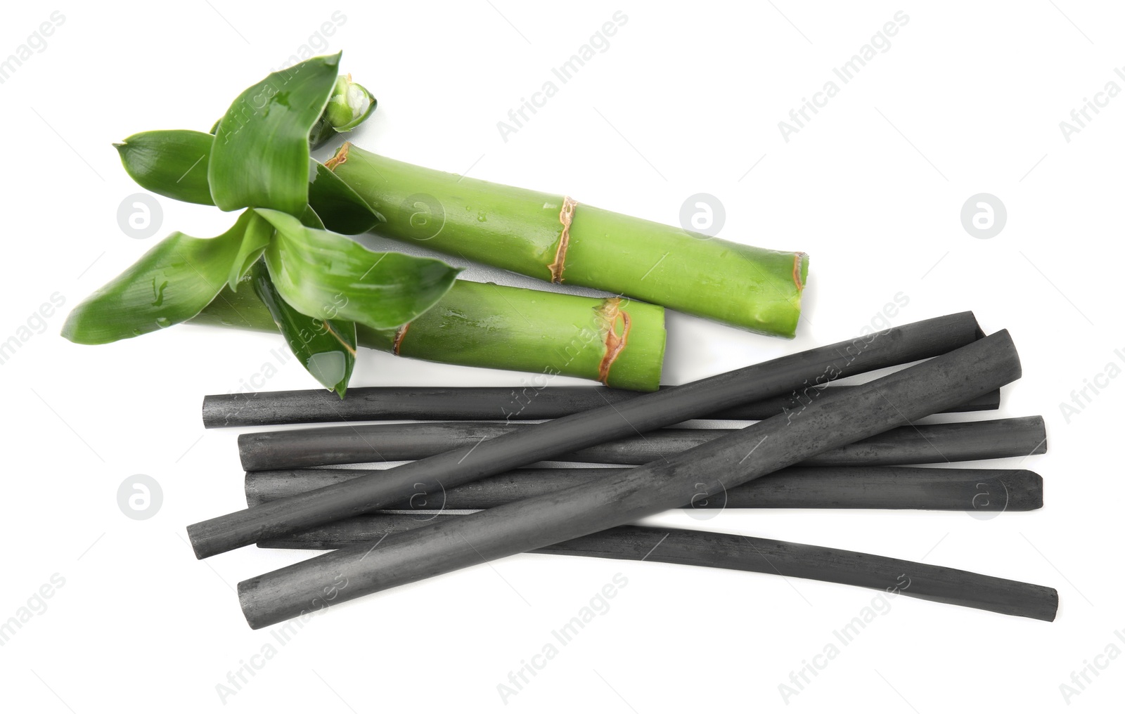 Photo of Fresh bamboo and charcoal on white background, top view