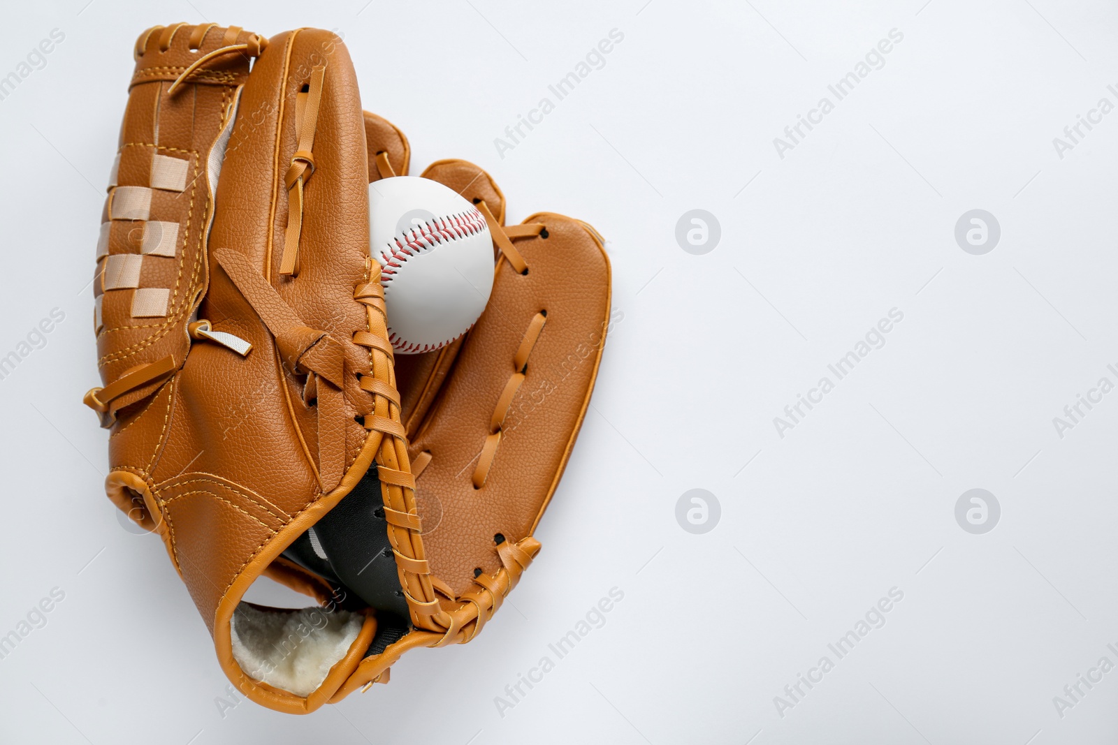 Photo of Catcher's mitt and baseball ball on white background, top view with space for text. Sports game